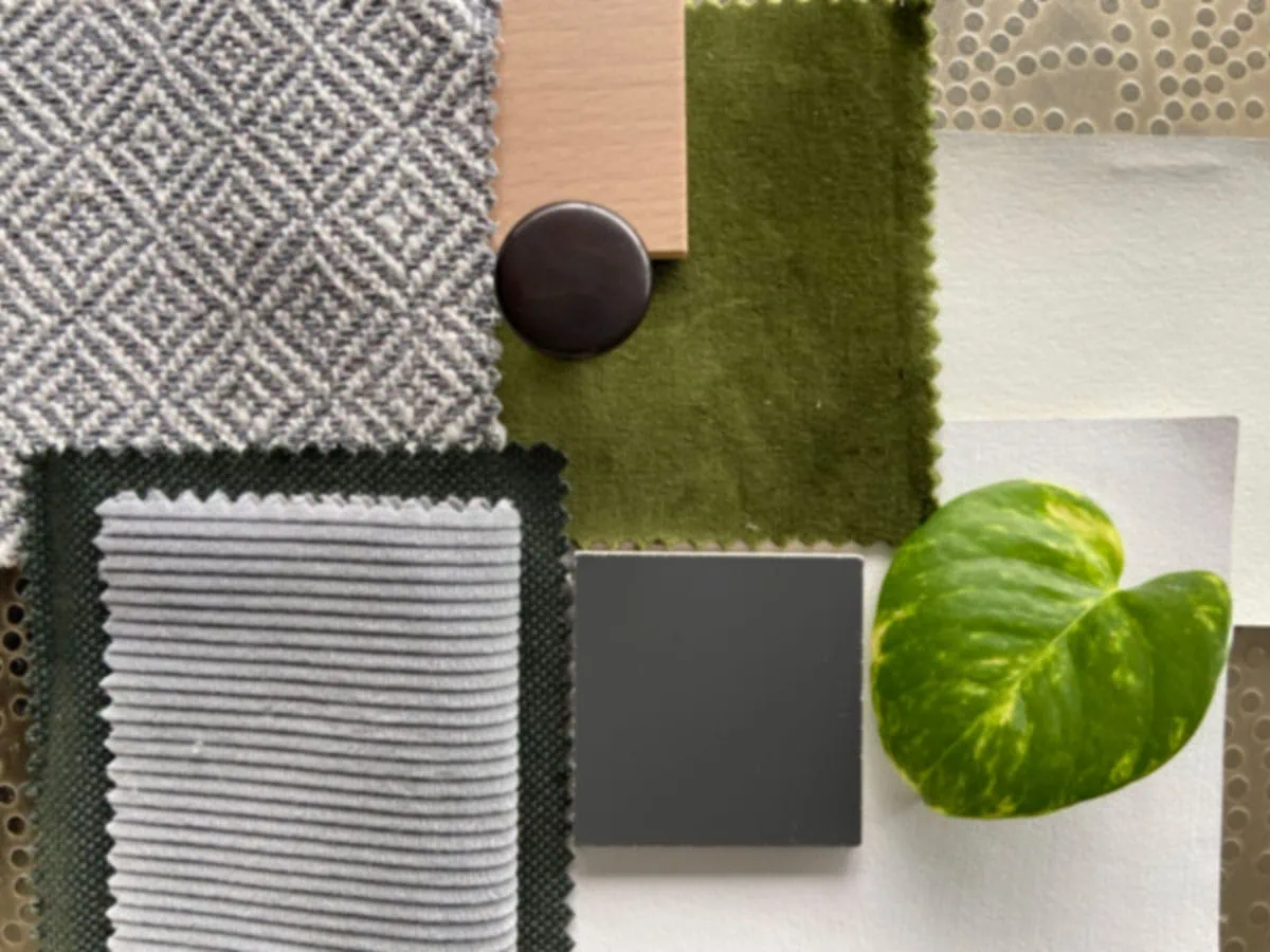 A mood board with fabric swatches including grey herringbone, ribbed grey, olive green, and a taupe pattern, with a green leaf and dark button accent.